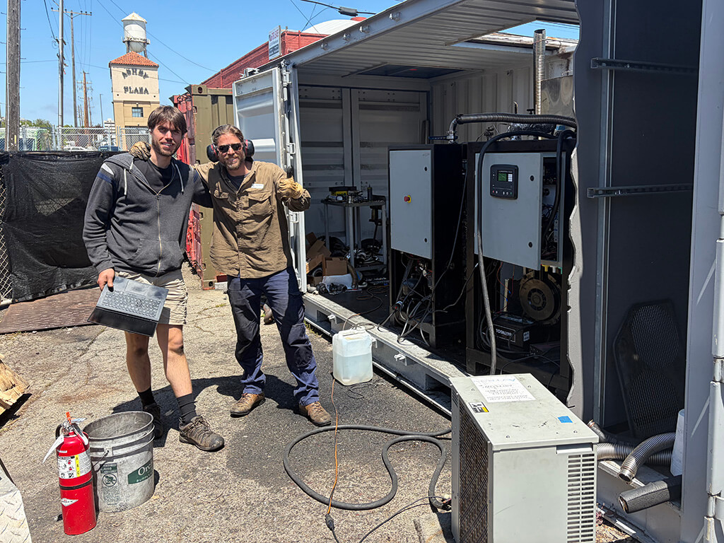 FFRD and APL staff arm in arm inform of gasifier gensets